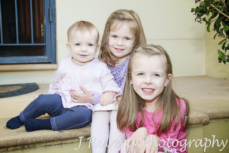 3 sisters sitting on steps - family portrait photography sydney
